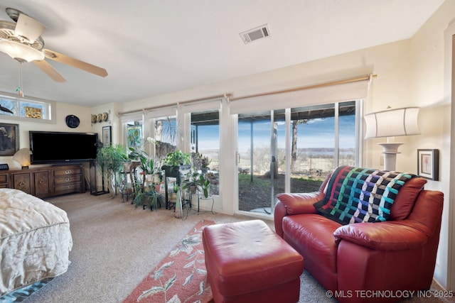 3126 E 490th Rd, Pryor, OK 74361 - living area featuring ceiling fan, visible vents, a healthy amount of sunlight, and carpet