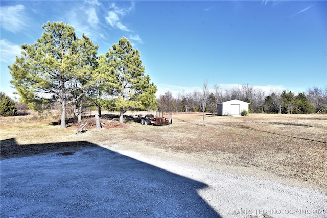 view of yard featuring an outbuilding and a detached garage