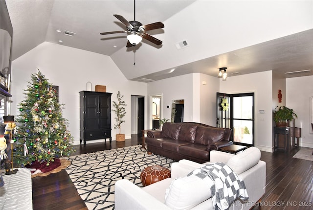 living area featuring visible vents, a ceiling fan, vaulted ceiling, wood finished floors, and baseboards