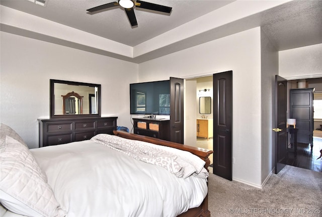 bedroom with carpet, visible vents, a ceiling fan, ensuite bath, and baseboards