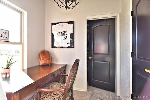 carpeted home office with baseboards