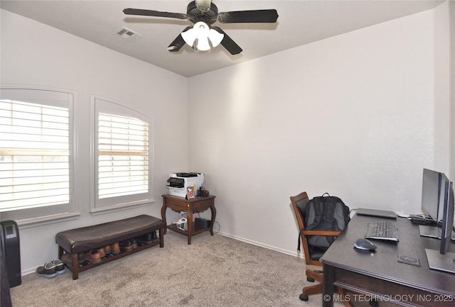 home office with ceiling fan, carpet floors, and visible vents