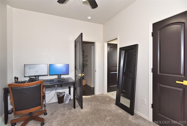 office space with ceiling fan, baseboards, and carpet flooring