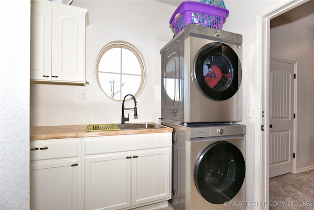 clothes washing area with stacked washer and dryer, cabinet space, a sink, and light colored carpet