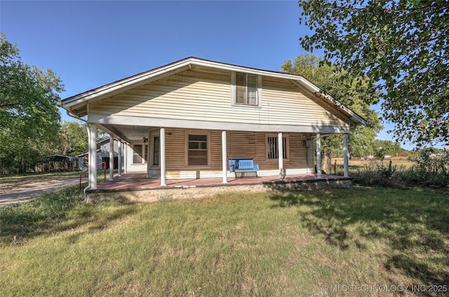 back of house with a porch and a yard