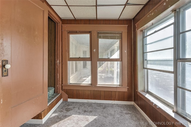 unfurnished sunroom featuring a paneled ceiling