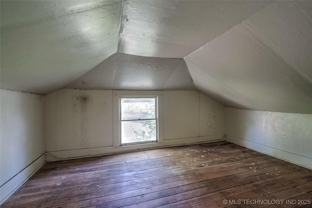 bonus room featuring vaulted ceiling and hardwood / wood-style flooring