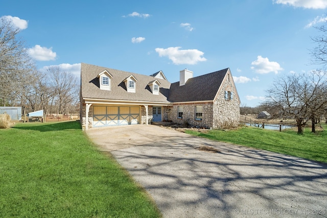 cape cod home with aphalt driveway, a shingled roof, a front yard, a garage, and stone siding