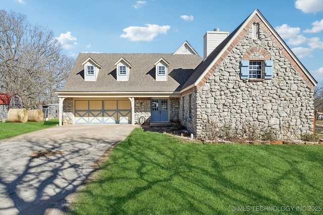 cape cod home with a garage, driveway, a front lawn, and stone siding