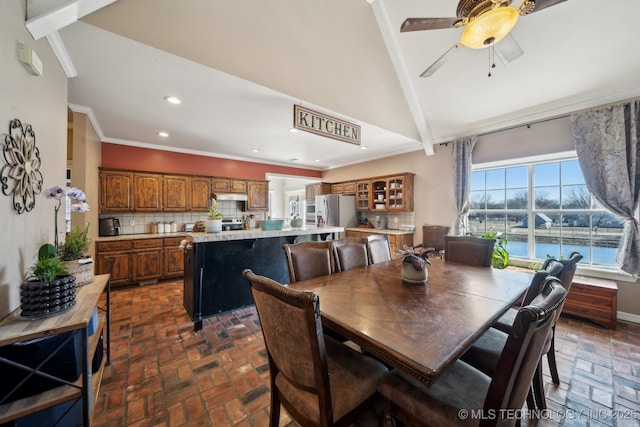 dining room with ceiling fan, high vaulted ceiling, brick floor, recessed lighting, and crown molding