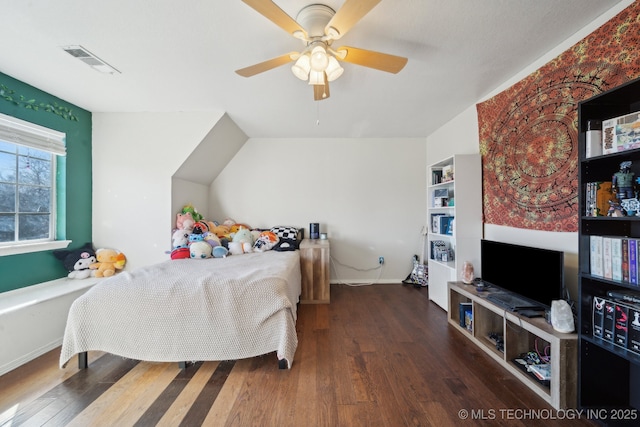 bedroom with a ceiling fan, visible vents, and wood finished floors