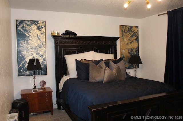 carpeted bedroom with a textured ceiling