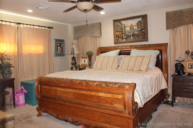 carpeted bedroom with a textured ceiling, a ceiling fan, visible vents, and recessed lighting