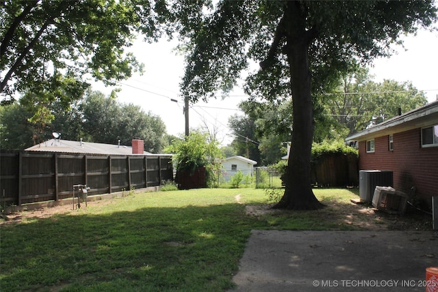 view of yard featuring a fenced backyard and central AC unit