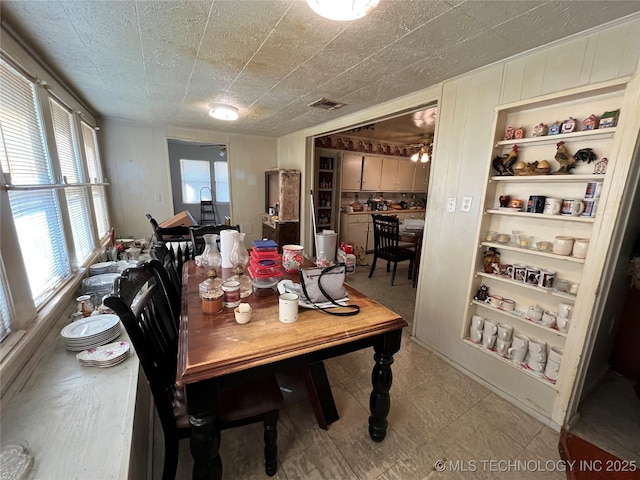 dining area featuring built in shelves and visible vents