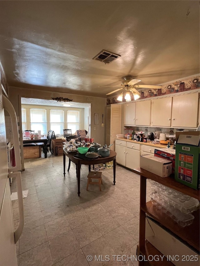 rec room with ceiling fan, light floors, and visible vents