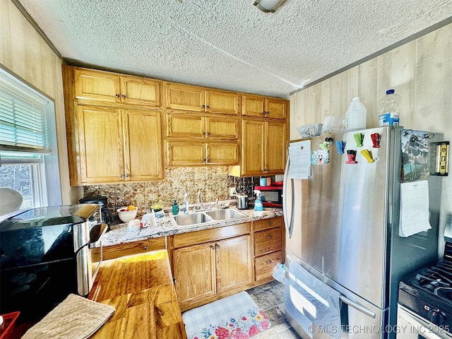 117 S Bluff Ave, Tahlequah, OK 74464 - kitchen with a sink, freestanding refrigerator, a textured ceiling, backsplash, and light countertops