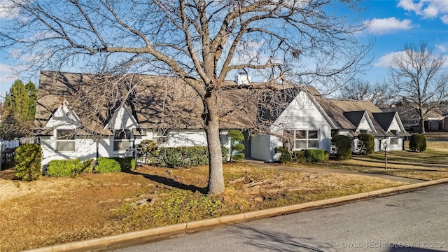 english style home featuring brick siding