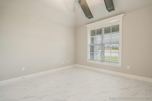 spare room with baseboards and marble finish floor