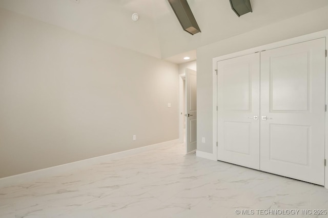 unfurnished bedroom with baseboards, a closet, recessed lighting, and marble finish floor