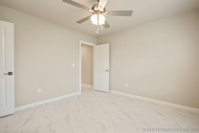 unfurnished bedroom with a ceiling fan, baseboards, and marble finish floor
