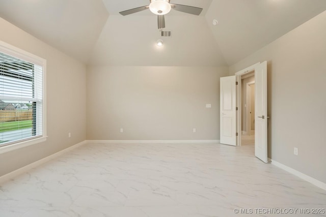 empty room featuring ceiling fan, visible vents, vaulted ceiling, baseboards, and marble finish floor