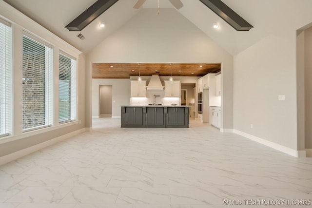 unfurnished living room featuring baseboards, marble finish floor, visible vents, and high vaulted ceiling