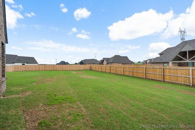 view of yard with a fenced backyard