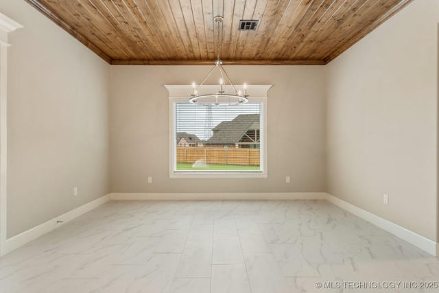 spare room featuring crown molding, a notable chandelier, marble finish floor, baseboards, and visible vents