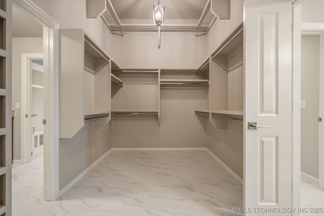 spacious closet featuring marble finish floor
