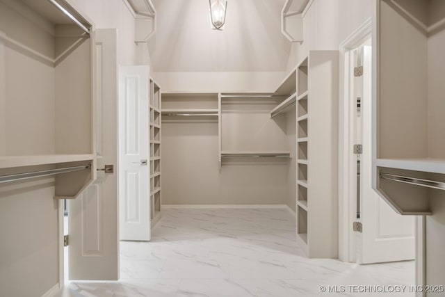 spacious closet with marble finish floor