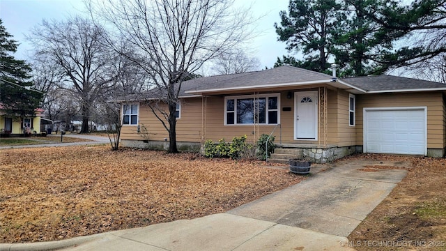 view of front of property featuring crawl space, driveway, a garage, and roof with shingles