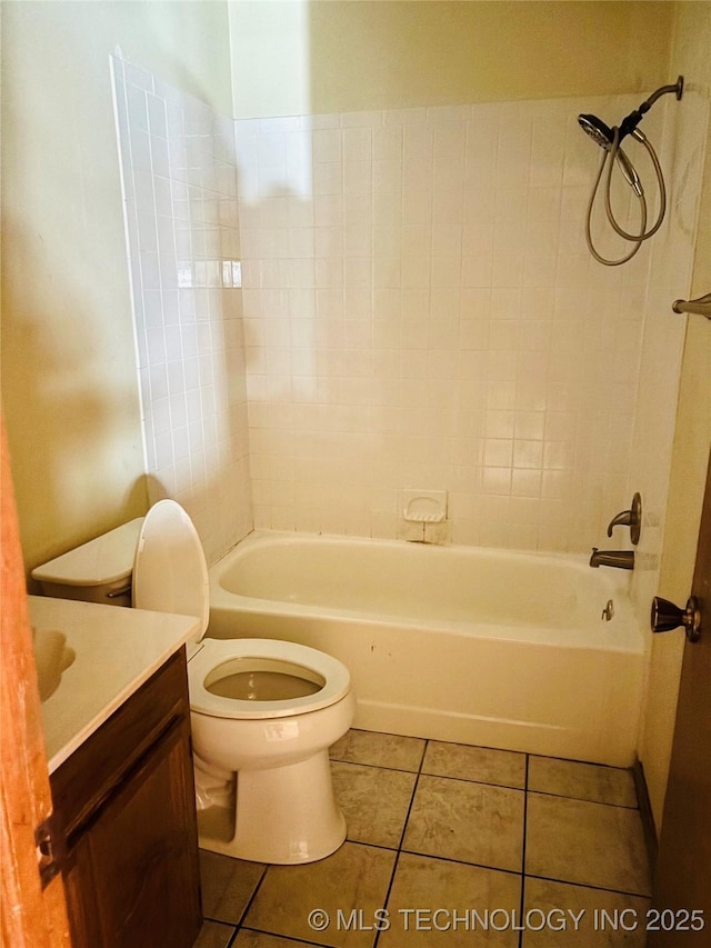 bathroom with toilet, shower / bath combination, tile patterned flooring, and vanity