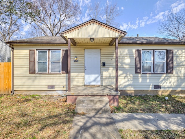 view of front of home featuring crawl space, fence, and roof with shingles