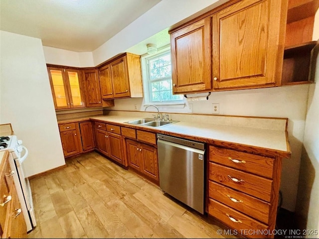 kitchen featuring a sink, white stove, brown cabinets, and dishwasher