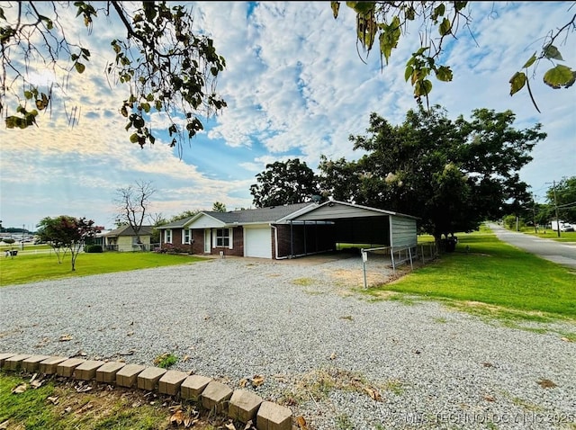 view of front of home featuring a front yard, brick siding, and driveway
