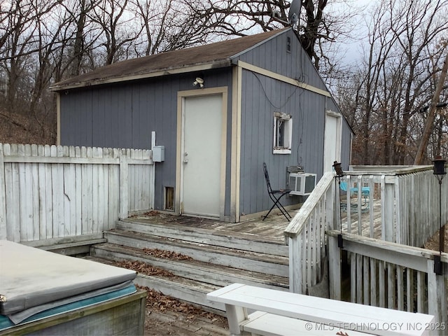 view of outbuilding featuring an outbuilding and fence