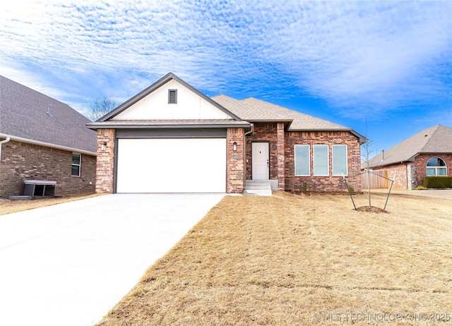 view of front of property featuring driveway, roof with shingles, an attached garage, central AC, and brick siding