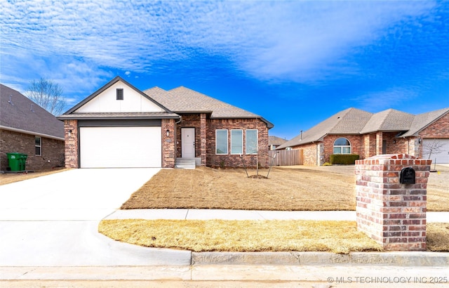 view of front facade with driveway, a garage, roof with shingles, fence, and brick siding