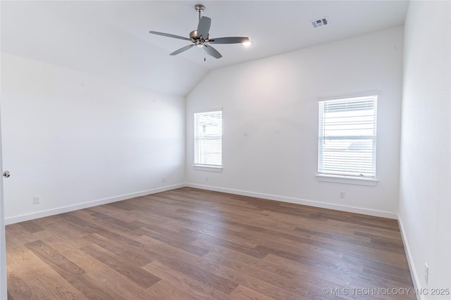 unfurnished room featuring a ceiling fan, baseboards, visible vents, and wood finished floors