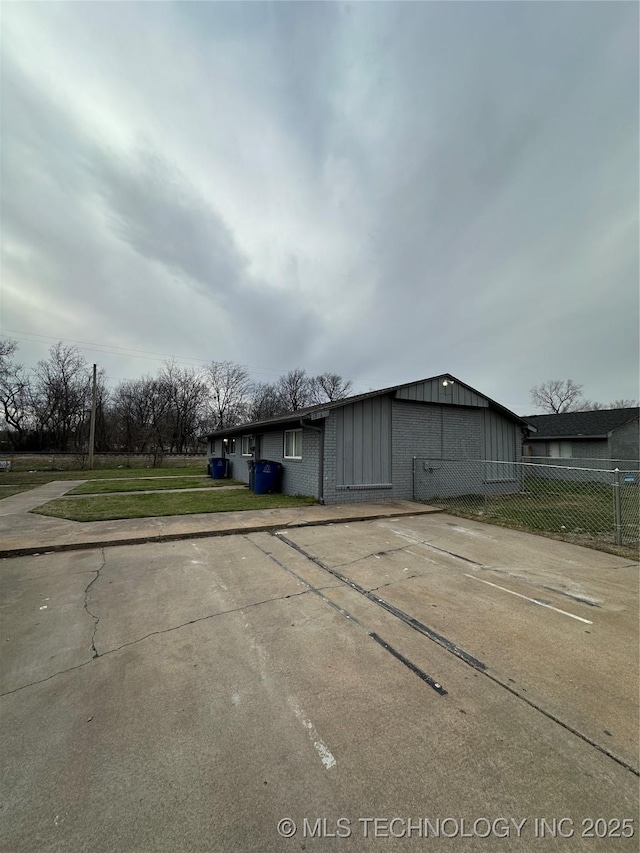 view of outbuilding featuring fence