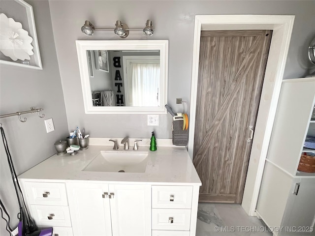 bathroom with marble finish floor and vanity