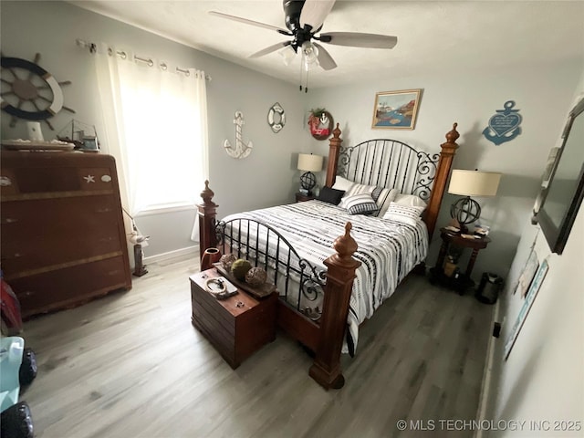 bedroom with light wood finished floors and ceiling fan