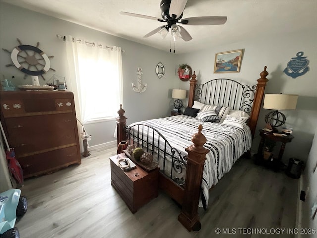 bedroom featuring light wood finished floors and a ceiling fan