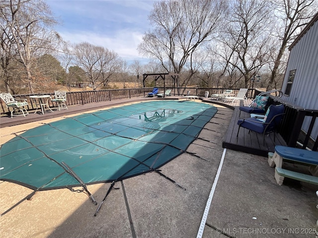 view of pool featuring a wooden deck and a fenced in pool