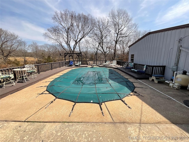 view of pool with a deck, a fenced in pool, and a patio