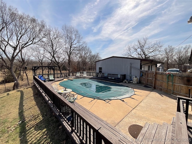 view of swimming pool featuring a fenced in pool, a patio area, and fence