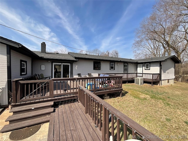 wooden deck with a lawn and cooling unit