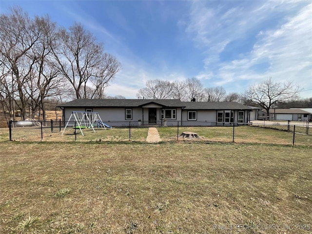 view of front facade featuring a fenced backyard, a playground, and a front yard