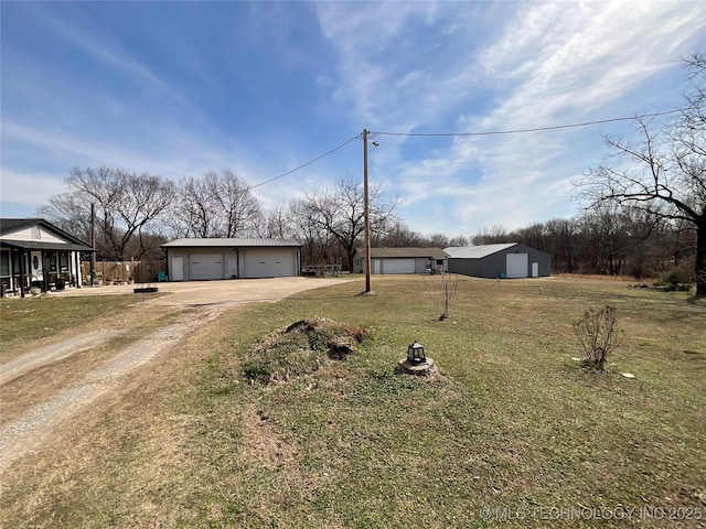 view of front facade featuring a front yard, a detached garage, and an outdoor structure